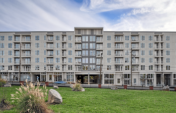 a large apartment building with a green lawn in front of it at Link Apartments® Canvas, Atlanta, GA, 30312