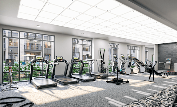 a gym with cardio equipment and windows in a large room at Link Apartments® Broad Ave, Memphis, Tennessee