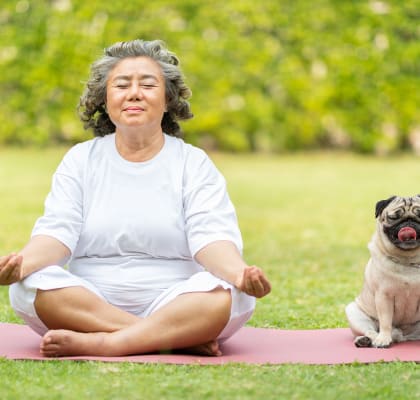 Woman doing yoga with pet dog