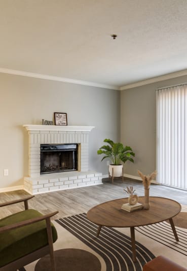 a living room with a fireplace and a couch and a table