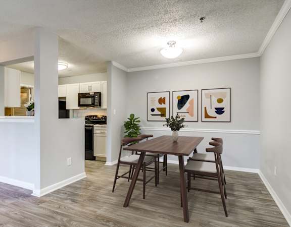a dining room with a table and chairs and a kitchen