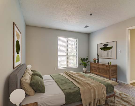 a bedroom with a bed and a dresser and a window
