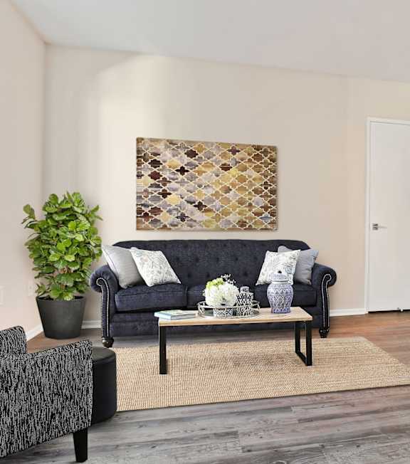 a living room with a spiral staircase and a couch and a table at Palm Royale Apartments, Los Angeles, CA