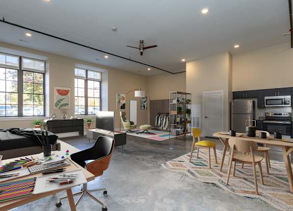 WM242 Studios, expansive studios with polished floors, large kitchens, windows, and ceiling fans.