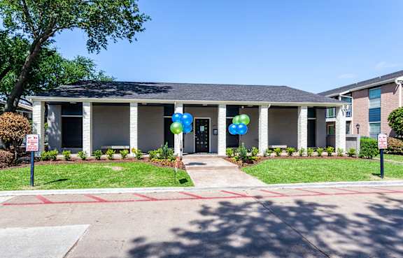 the front of a house with balloons in front of it