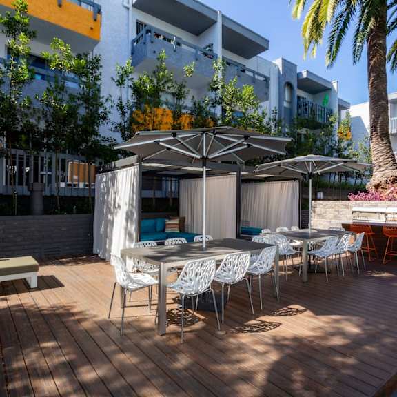 A patio with a table and chairs under a canopy.