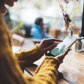 Woman on cell phone in cafe