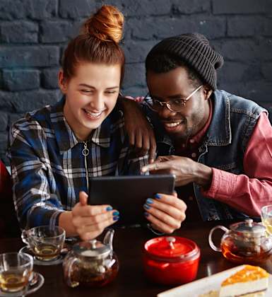 Lifestyle photo of friends looking at a tablet
