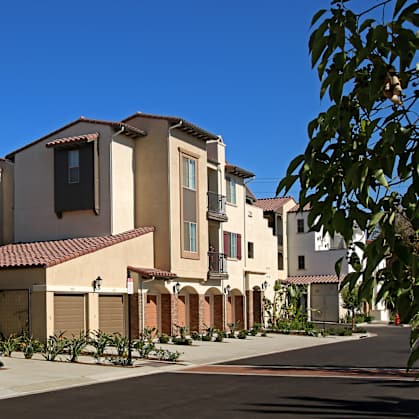 A row of houses with brown garage doors.