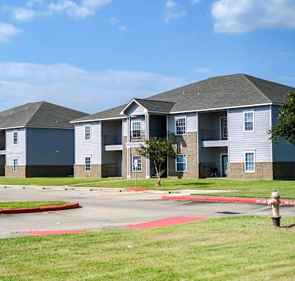 a row of townhomes with a fire hydrant in the foreground