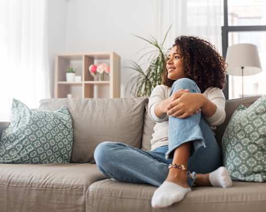 Lifestyle photo of woman at home on the couch