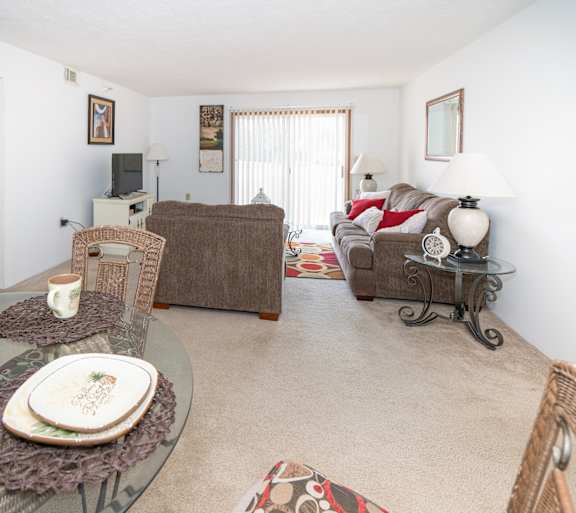 a living room with a couch and a table and a television