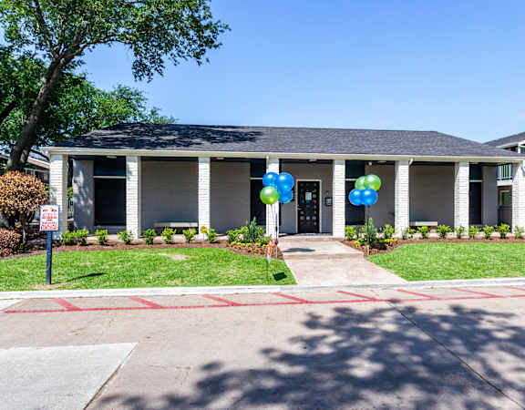 the front of a house with balloons in front of it