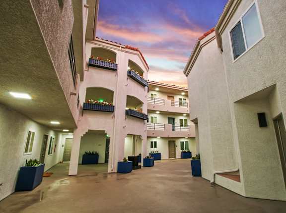 a view of the courtyard at sunset at the resort at at Alon Apartments, Los Angeles, CA