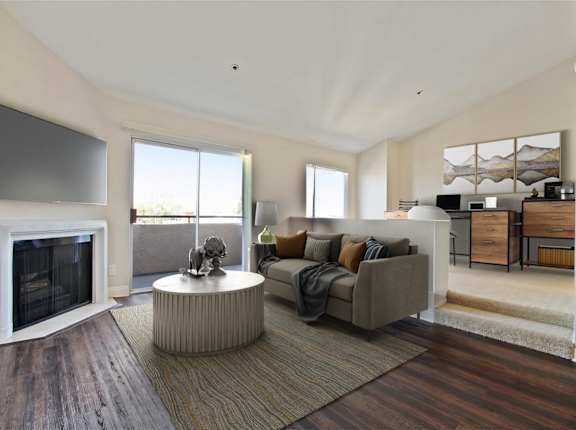 a living room with a couch and a fireplace at Palm Royale Apartments, Los Angeles, CA