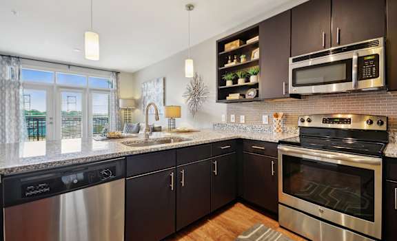 a kitchen with stainless steel appliances and granite counter tops