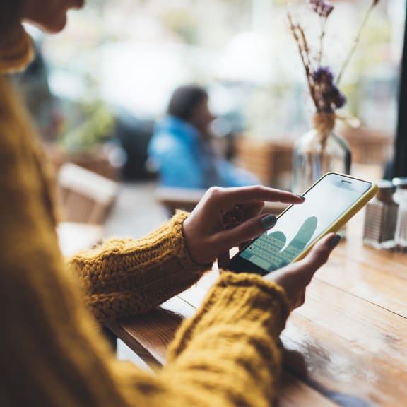 Woman on cell phone in cafe at Laurel Creek, Fairfield, CA, 94533