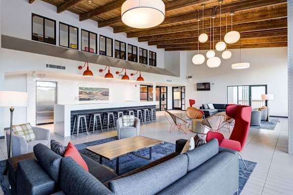 A modern living room with a grey couch and a wooden coffee table at Ashford Belmar in Lakewood, CO