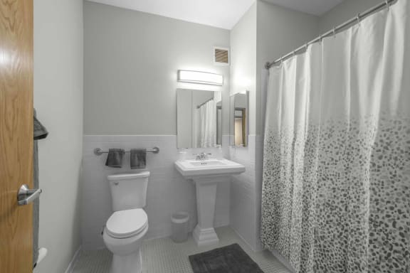 a bathroom with a toilet sink and shower