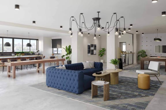 a rendering of a living room with a blue couch and a dining room table in the background