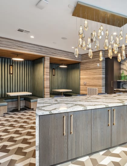 a large kitchen with marble countertops and a chandelier
