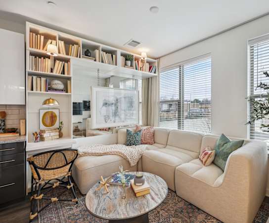 a living room with a couch and a table     and a window at Link Apartments® Broad Ave, Memphis, Tennessee