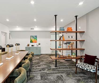 a living room with a long wooden table and chairs