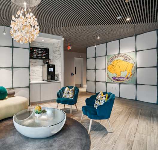a living room with a couch and chairs and a coffee table  at Link Apartments® Mint Street, Charlotte, North Carolina