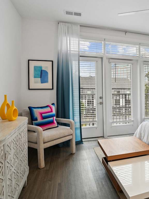 a bedroom with a bed and a sliding glass door  at Link Apartments® Mint Street, Charlotte, North Carolina