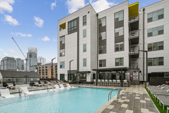 a swimming pool in front of a building  at Link Apartments® Mint Street, Charlotte, North Carolina