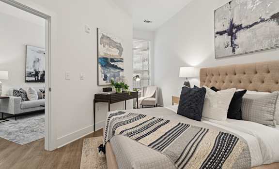a bedroom with a large bed and a mirror