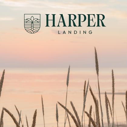 A logo with the text "HARPER LANDING" is displayed over a background of tall grasses.