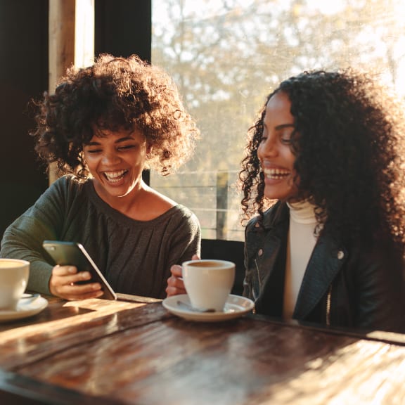 Lifestyle photo of two friends at a coffee shop
