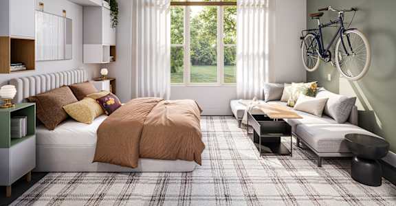 a bedroom with a bed and a couch and a ceiling fan at Link Apartments® CYKEL Apartments, Charlotte , NC