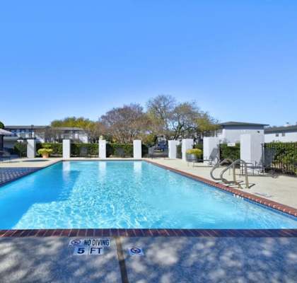 A swimming pool with a depth marker reading 5 feet.