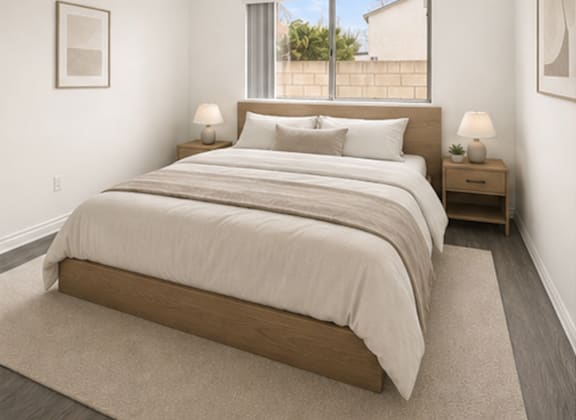 A bedroom with a large bed and two nightstands.