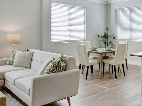 A white living room with a couch, chairs, and a coffee table. at Apex Mission Valley, California, 92108