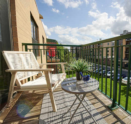A balcony with a table and chairs