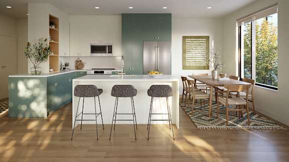 A kitchen with a bar area and a dining table.