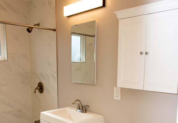 a small bathroom with a sink toilet and shower
