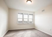 Thumbnail 5 of 11 - Bedroom with a 3 panel window, off-white walls and carpeted floors