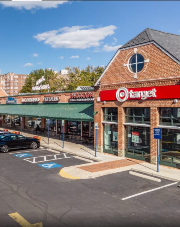 a brick building with a target sign on the front and a parking lot in front of it