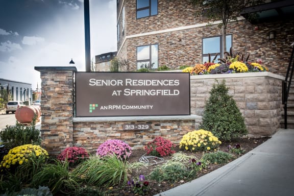 exterior of entrance with building sign that states "Senior Residences at Springfield; an RPM Community"