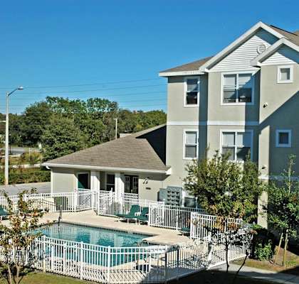 a large swimming pool in front of a building at Oak Glen Apartments, Orlando, 32808