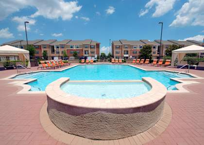 our apartments offer a large pool with lounge chairs and umbrellas at The Atlantic McKinney Ranch, McKinney, 75070