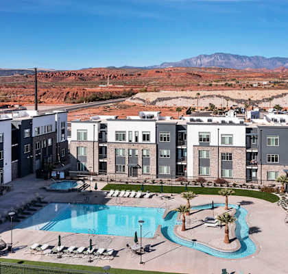 an aerial view of an apartment complex with a large swimming pool
