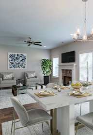 A dining room with a white table and chairs.