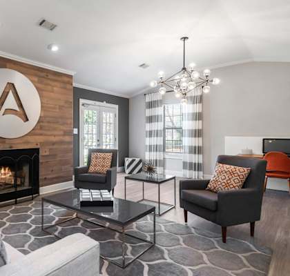 a living room with a fireplace and a wooden wall