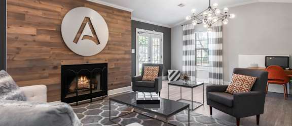a living room with a fireplace and a wooden wall