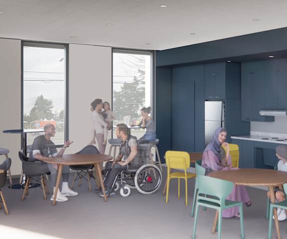 A group of people are gathered around a table in a room with blue walls.
